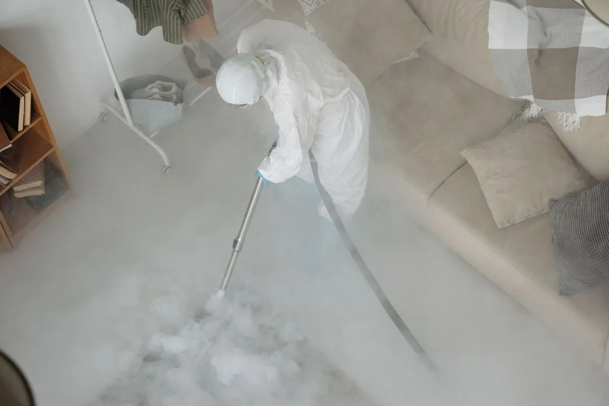 Biohazard cleanup technician in protective equipment, Midland, PA